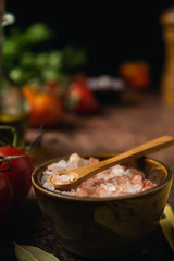 Close up of himalayan pink salt crystals on dark rustic background