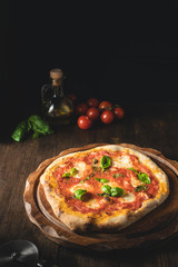 Italian pizza margarita on dark rustic background, copy space