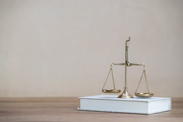 Law scales on wooden desk concept for justice and equality