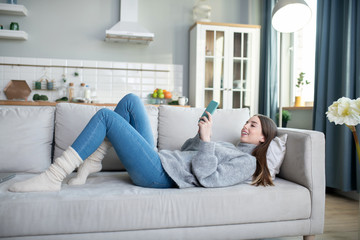 Young girl in a grey sweater spending her day at home