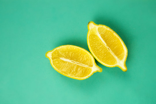 Close Up Cut Yellow Lemon On Green Isolated Background. Food, Vegan, Vitamin, Citrus Healthy Food Concept