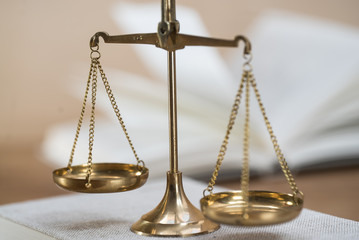 Law scales on wooden desk concept for justice and equality