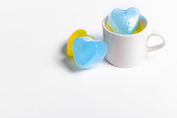 Small cake shaped in a coffee cup on a white background for valentines day.