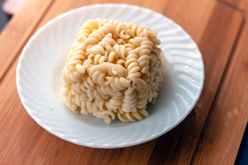 cube block shaped Leftover Cooked Pasta in the plate 