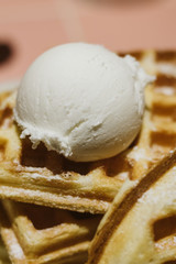 a scoup of ice cream on handmade waffle