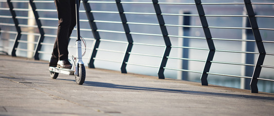 Young businessman on e scooter in the city