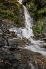 Obraz na płótnie Canvas Waterfall at Mount Aspiring National Park. Haast highway 6. Westcoast New Zealand.