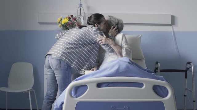 Woman visiting her senior mother at the hospital