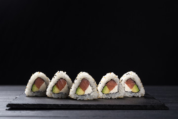 Sushi Rolls with tuna on a dark background. Japanese traditional roll with tuna. Sushi set on a...