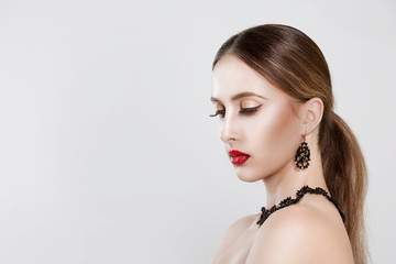 Natural beauty. Portrait of young woman eyes closed with red and black gradient lips  against white background wall