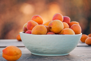 Apricots in a bowl and on a table