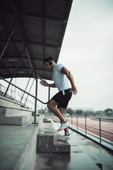 Fototapeta na wymiar Man working out on stadium steps