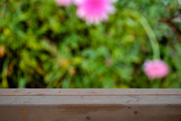 Wood table top on blurred green background - can be used for montage or display your products