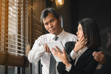 The hand of a flirtatious businessman is embracing his female secretary during counseling.