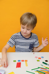 Little boy preparing for elementary school doing simple math exercises