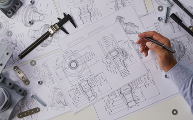 Engineer technician designing drawings mechanical parts engineering Engine.manufacturing factory...