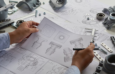 Engineer technician designing drawings mechanical parts engineering Engine.manufacturing factory...