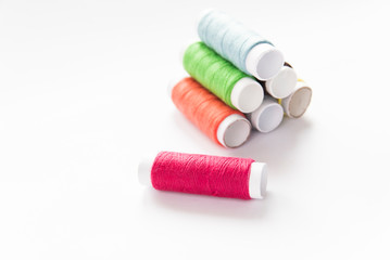 colorful spools of thread close-up on a white background