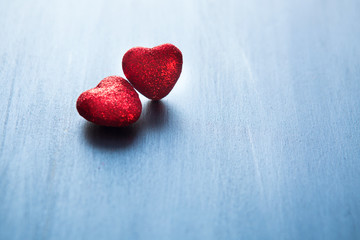 Two hearts of love close-up on a gray wooden background. Valentine's day greeting card. Love and holiday concept.