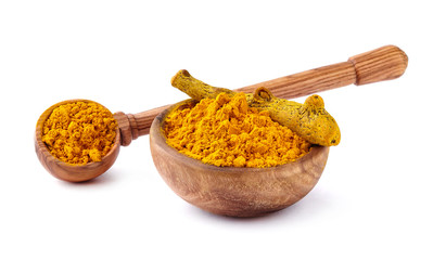 Turmeric rhizome and powder in wooden bowl on white background