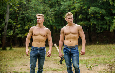 Dedicated to fitness. twins muscular men with axe. athletic man use ax. double force power....