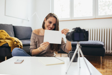 woman making video blog from her home