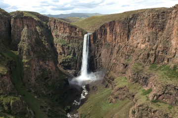 stunning waterfall running down a steap canyon
