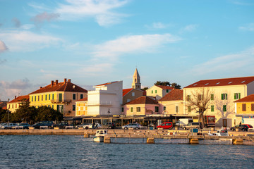 Small Dalmatian town of Biograd Na moru , Croatia. Old church belltower peeking above the buildings, biograd riviera