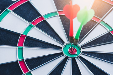 the abstract image of a dartboard laying on the table with darts embroidered. the concept of...