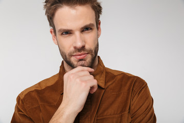 Portrait of unshaven young man posing and looking at camera
