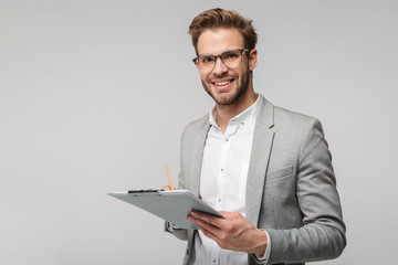 Portrait of happy young man in eyeglasses holding clipboard and smiling