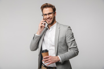 Portrait of smiling handsome man in eyeglasses talking on cellphone
