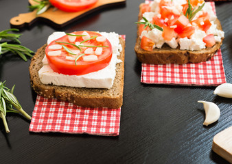 Healthy food. Vegetarian food. Appetizers with White Cheese, Tomatoes, Garlic and Rosemary