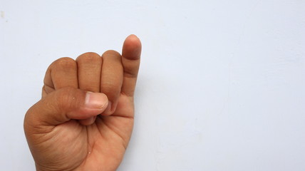 left hand photographed with the meaning of a symbol and white background, not in focus. blurry