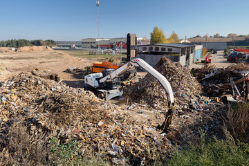 Excavator and shredder designed for pre-processing of materials municipal waste and construction...