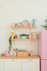 Kitchen shelves, wooden surface and pink fridge on white background. White kitchen interior counter top