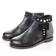 Black leather boots for girls with bow and pearls isolated on white. Side view