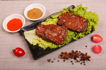 The delicious lamb ribs are roasted and cut into pieces, then put on the plate with sauce