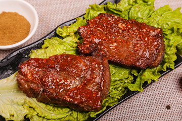 The delicious lamb ribs are roasted and cut into pieces, then put on the plate with sauce