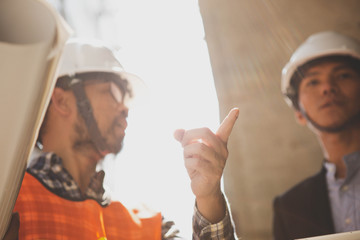Engineers oversaw the construction site skyscraper.