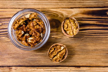 Cores of walnut in glass bowl on a wooden table. Top view