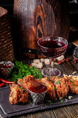 European cuisine in Ukrainian style. chicken legs and wings breaded with barbecue sauce. rustic...