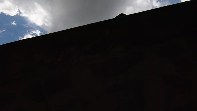 gopro follows a guy from an undershot how he jumps over some obstacles on a rooftop