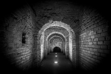 Brick tunnel archway made of red bricks as a passage between the two wings of a medieval castle....