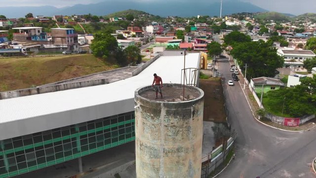 drone video of a freerunner doing capoeira on a tower in brazil