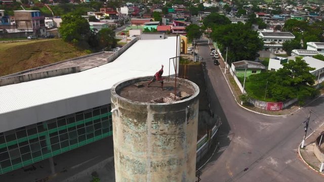 drone video of a freerunner doing capoeira on a tower in brazil