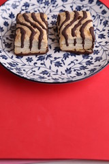 small chocolate cakes in color background