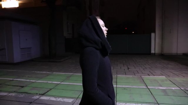 Girl taking a walk in the city in night time slow motion