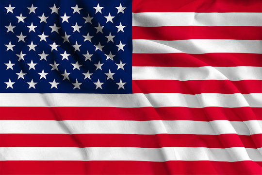 Red and white striped and blue with white stars American flag waving in the wind, close up. US national flag is a symbol of freedom and democracy. American country background.