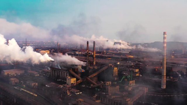 Aerial. GLOBAL WARMING. View of high chimney pipes with grey smoke. Pipes Pollute Industry Atmosphere With Smoke Ecology pollution, Industrial factory pollutes, smoke stacks exhaust pipes